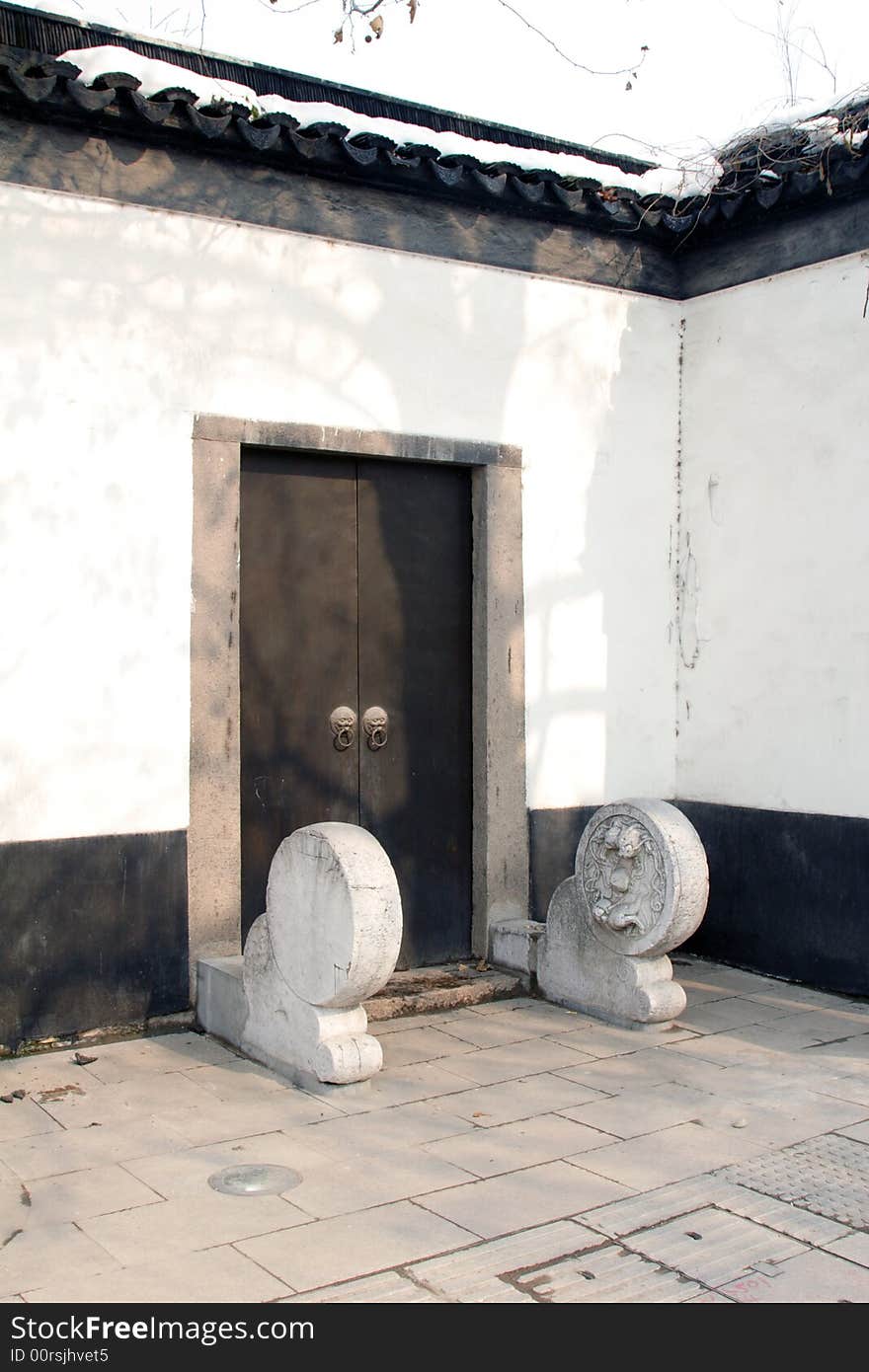 This picture is taken in Zhuozheng park in Suzhou ,China.A closed door with decoration of sunshine on it. This picture is taken in Zhuozheng park in Suzhou ,China.A closed door with decoration of sunshine on it.