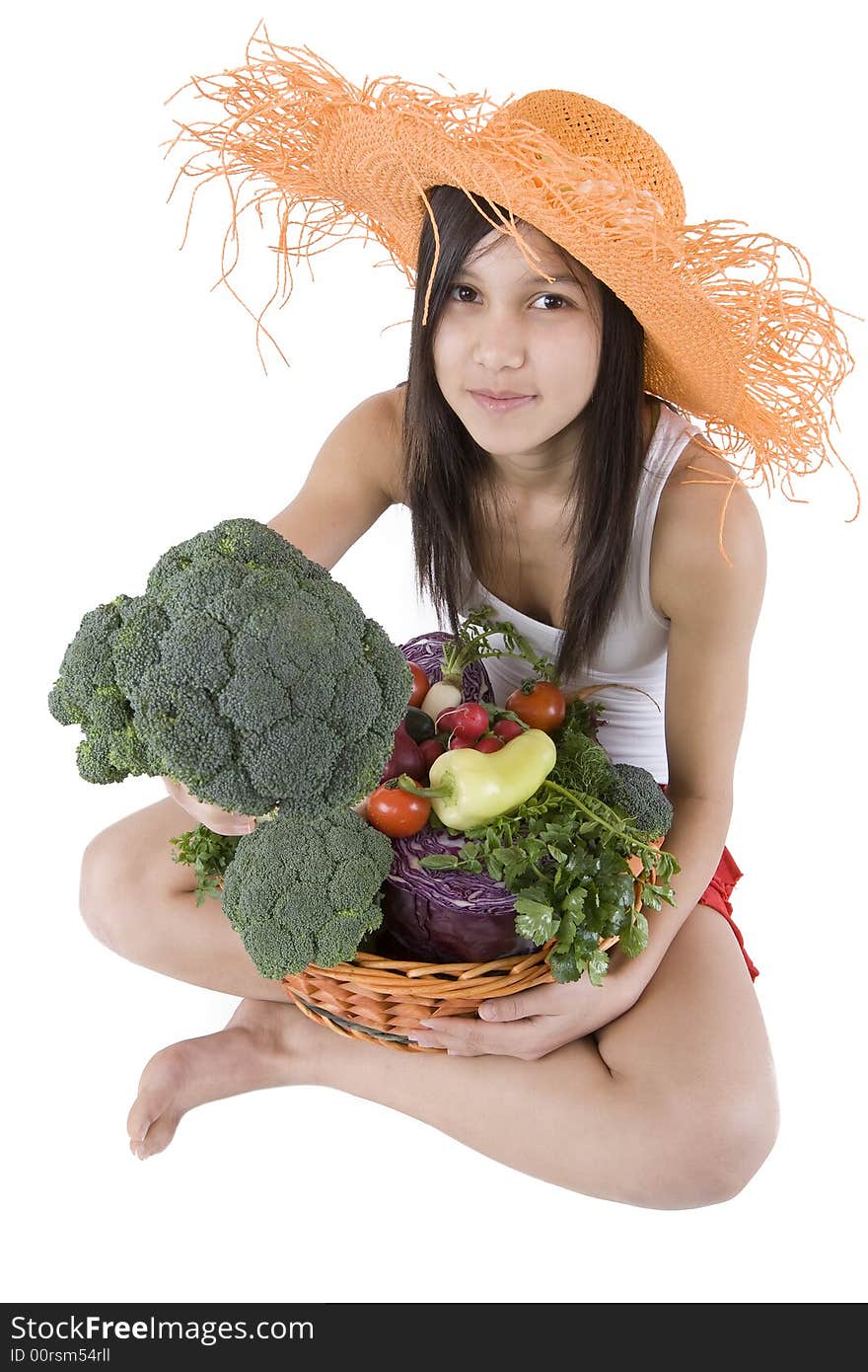 Teenager hold a basket of full vegetables before a white background. Teenager hold a basket of full vegetables before a white background