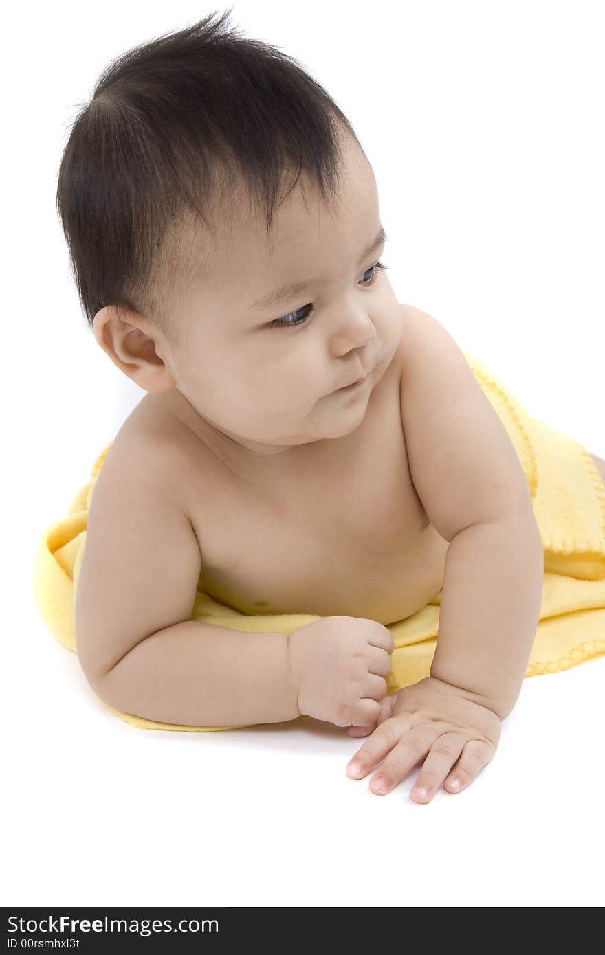 Charming baby with yellow soft cover before white background