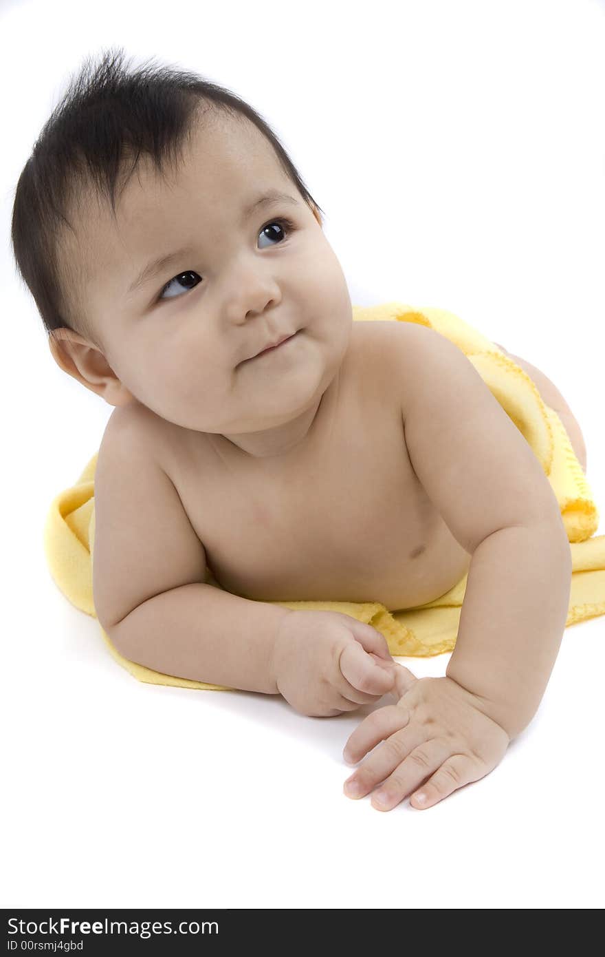 Charming baby with yellow soft cover before white background