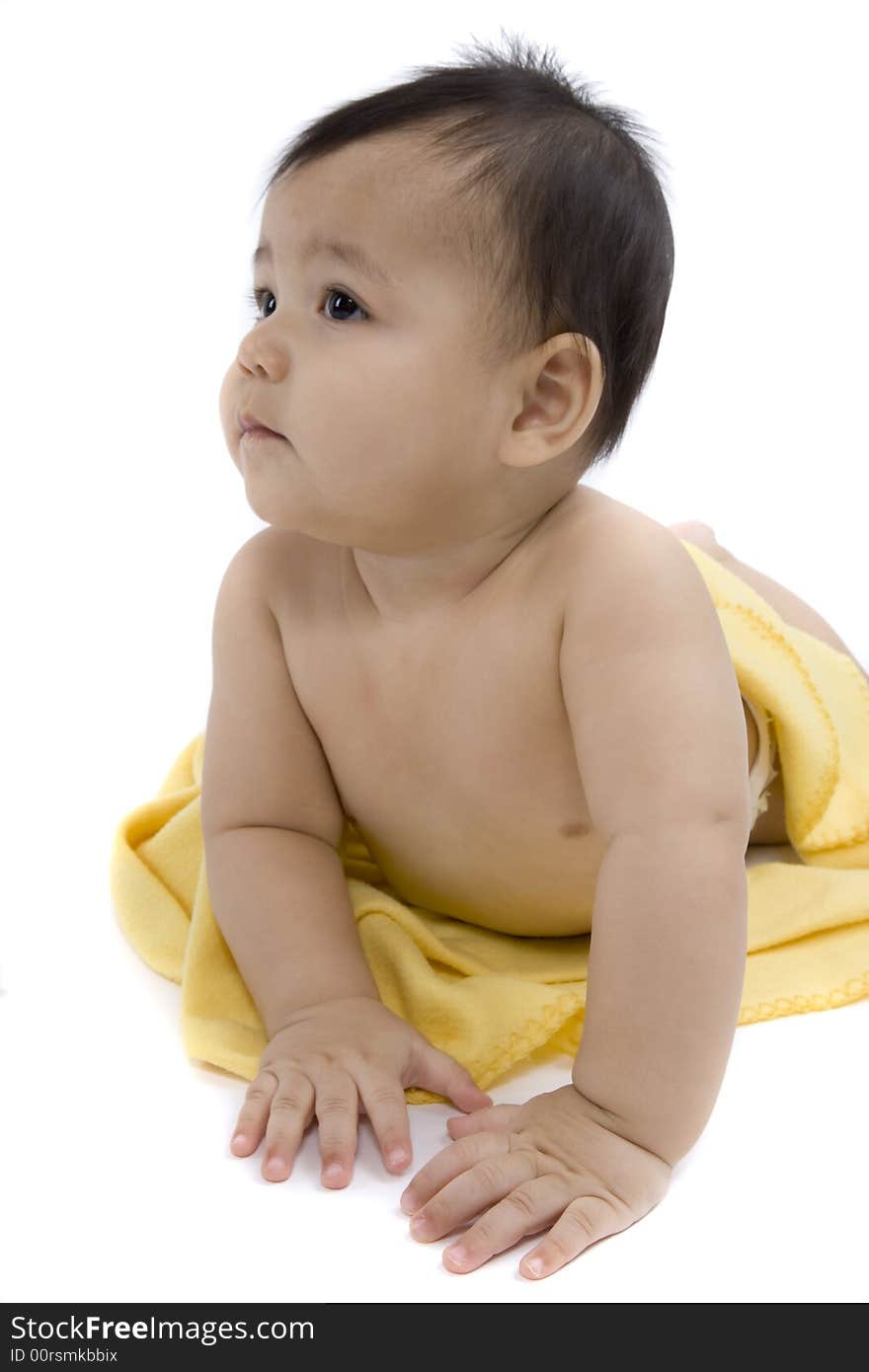 Charming baby with yellow soft cover before white background