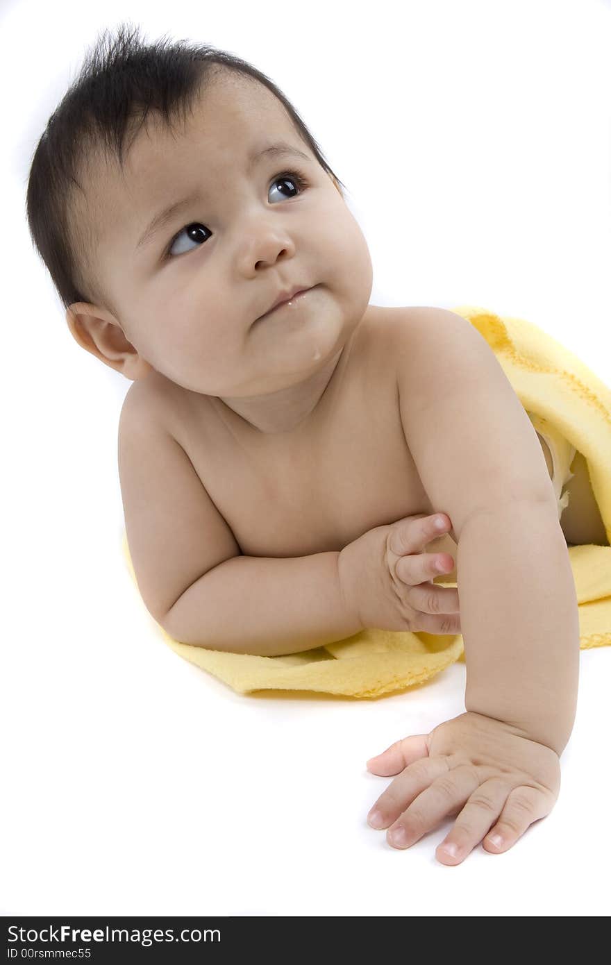 Charming baby with yellow soft cover before white background