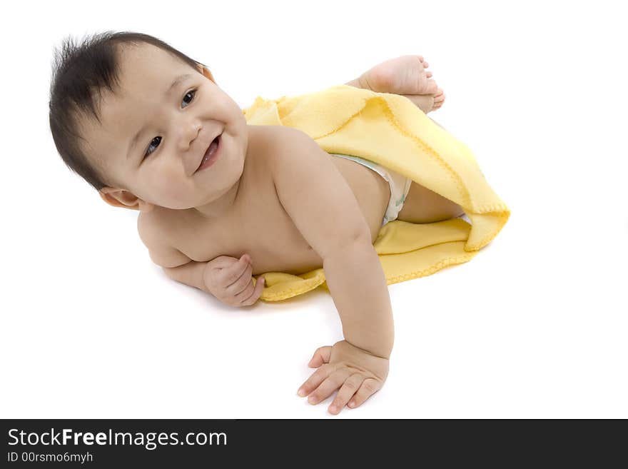 Charming baby with yellow soft cover before white background