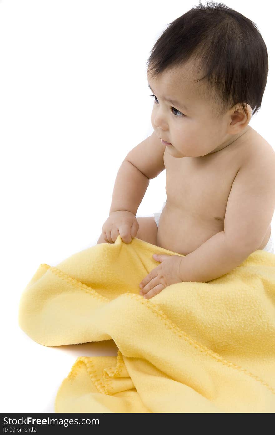 Charming baby with yellow soft cover before white background