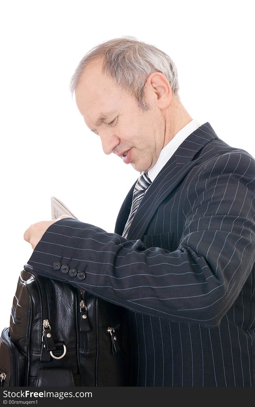 The adult businessman with a bag isolated on a white background. The adult businessman with a bag isolated on a white background