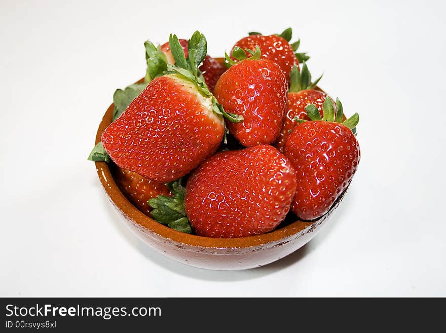 Bowl of strawberries on white background