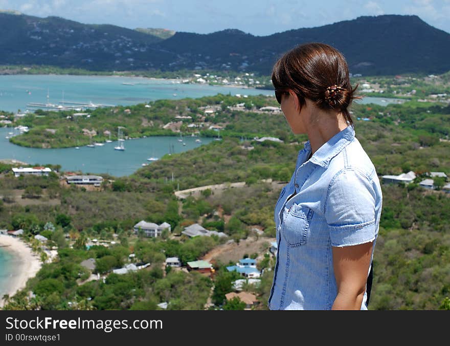 The girl is looking at Nelson's Bay on Antigua island.