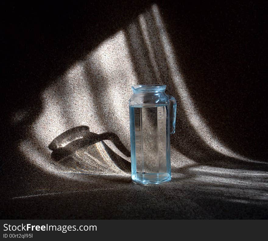 Photo of the carafe with water at the dark background