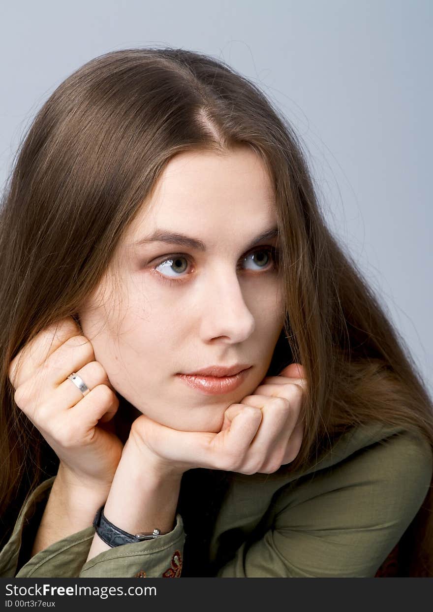 Girl with long hair with chin on hands. Girl with long hair with chin on hands