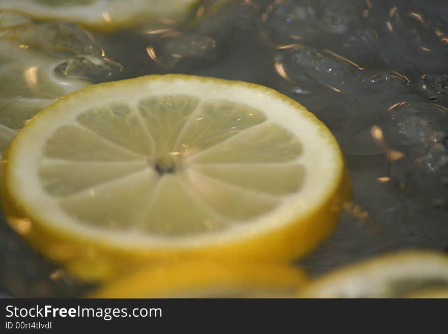 Lemon slices floating on ice cold water.