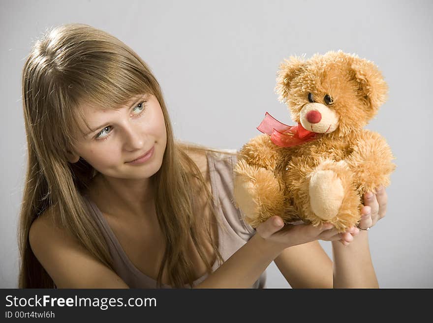 Beautiful young girl holding a teddy bear toy. Beautiful young girl holding a teddy bear toy