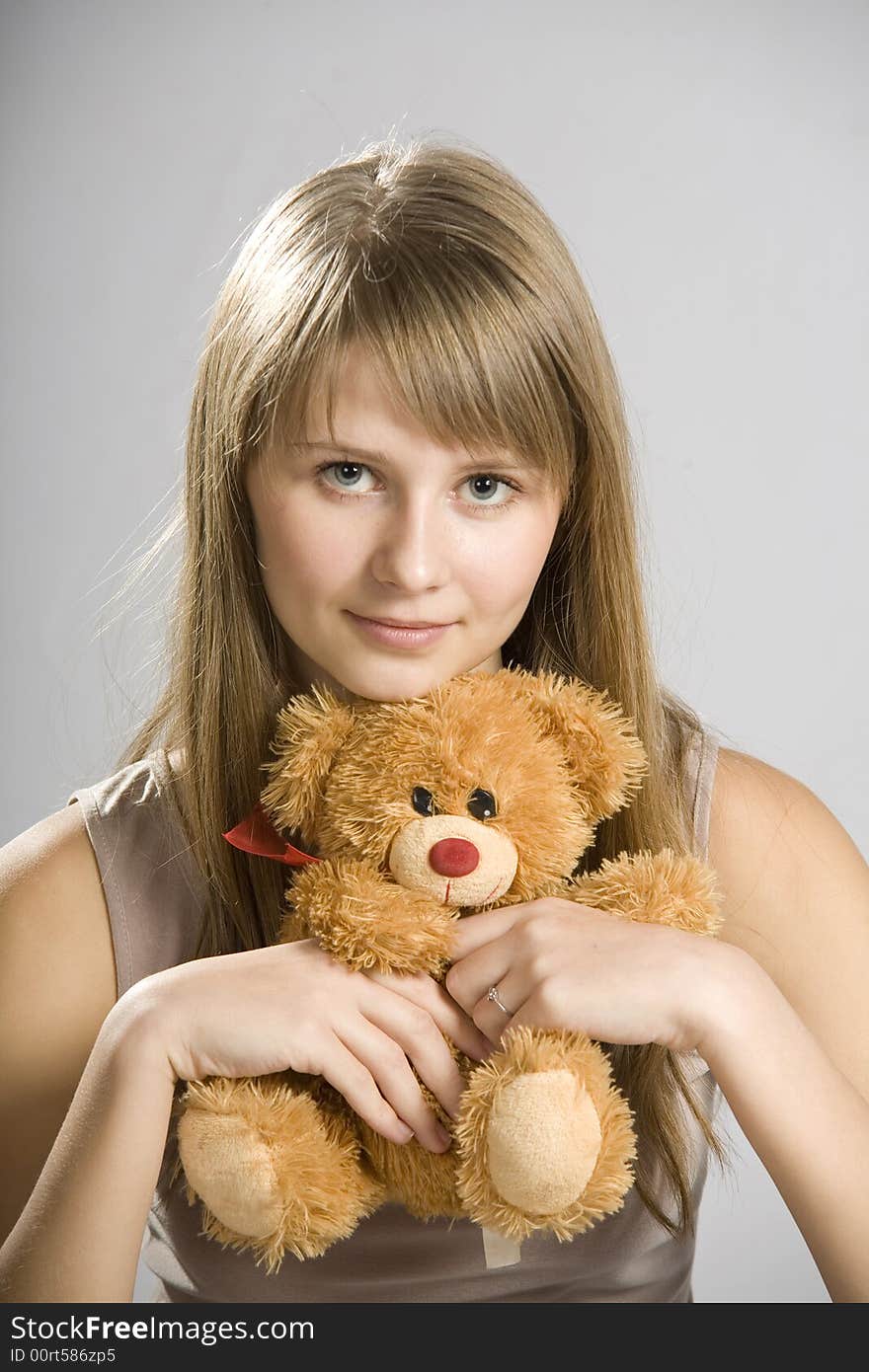 Beautiful young girl holding a teddy bear toy. Beautiful young girl holding a teddy bear toy