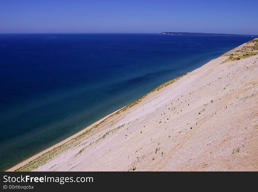 A steep dune and the colorful water of Lake Michigan. A steep dune and the colorful water of Lake Michigan