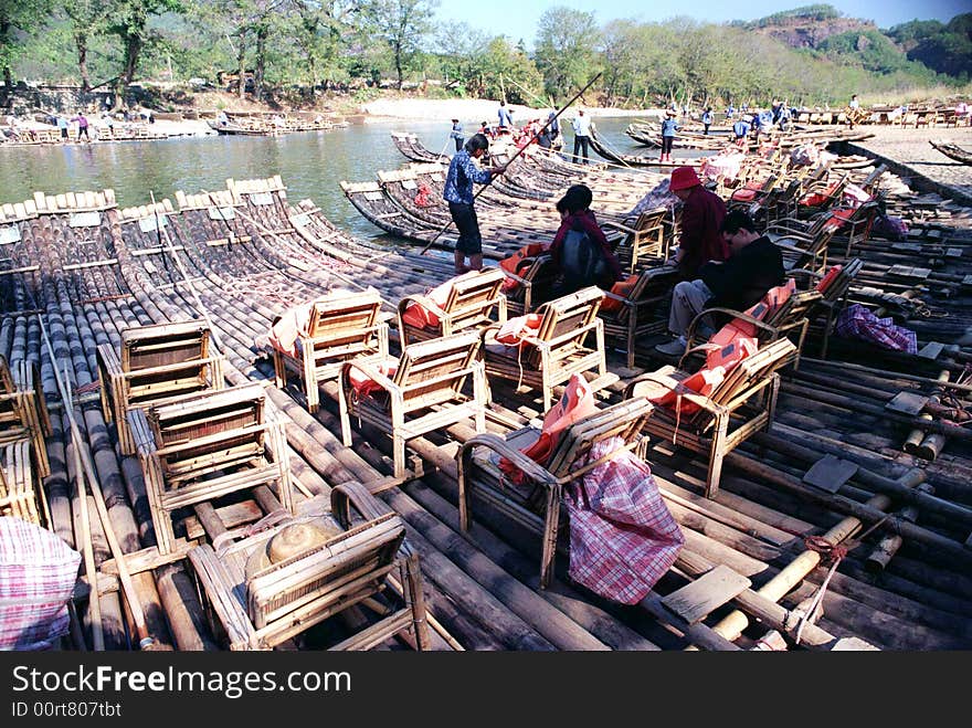 Tourists take baboom rafts sightseeing in a zigzag river in the Wuyishan Mountain,Fujian,China,Asia. Tourists take baboom rafts sightseeing in a zigzag river in the Wuyishan Mountain,Fujian,China,Asia.