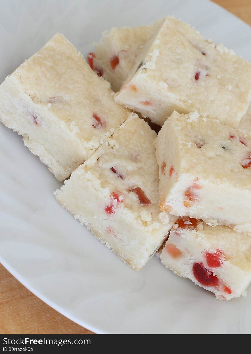 Several pieces of shortbread with candied fruit on a plate