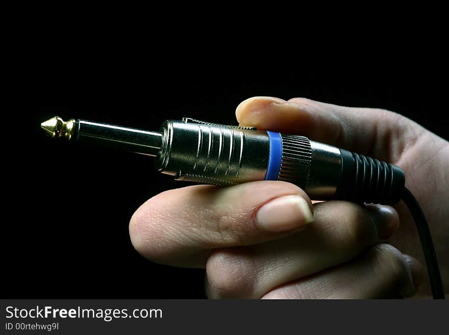 Woman hand holding two jacks on black. Woman hand holding two jacks on black