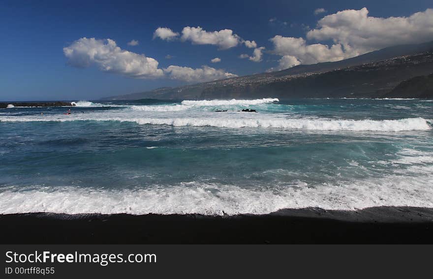 View of beautiful beach with dark sand. View of beautiful beach with dark sand