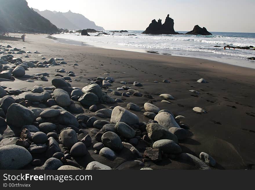 Stone coast with black sand. Stone coast with black sand