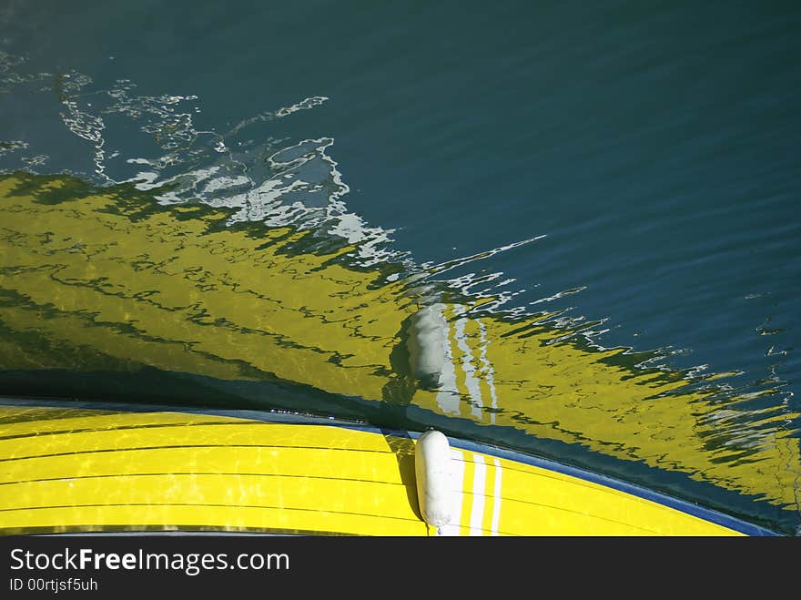 Yellow boat reflections in a port. Yellow boat reflections in a port