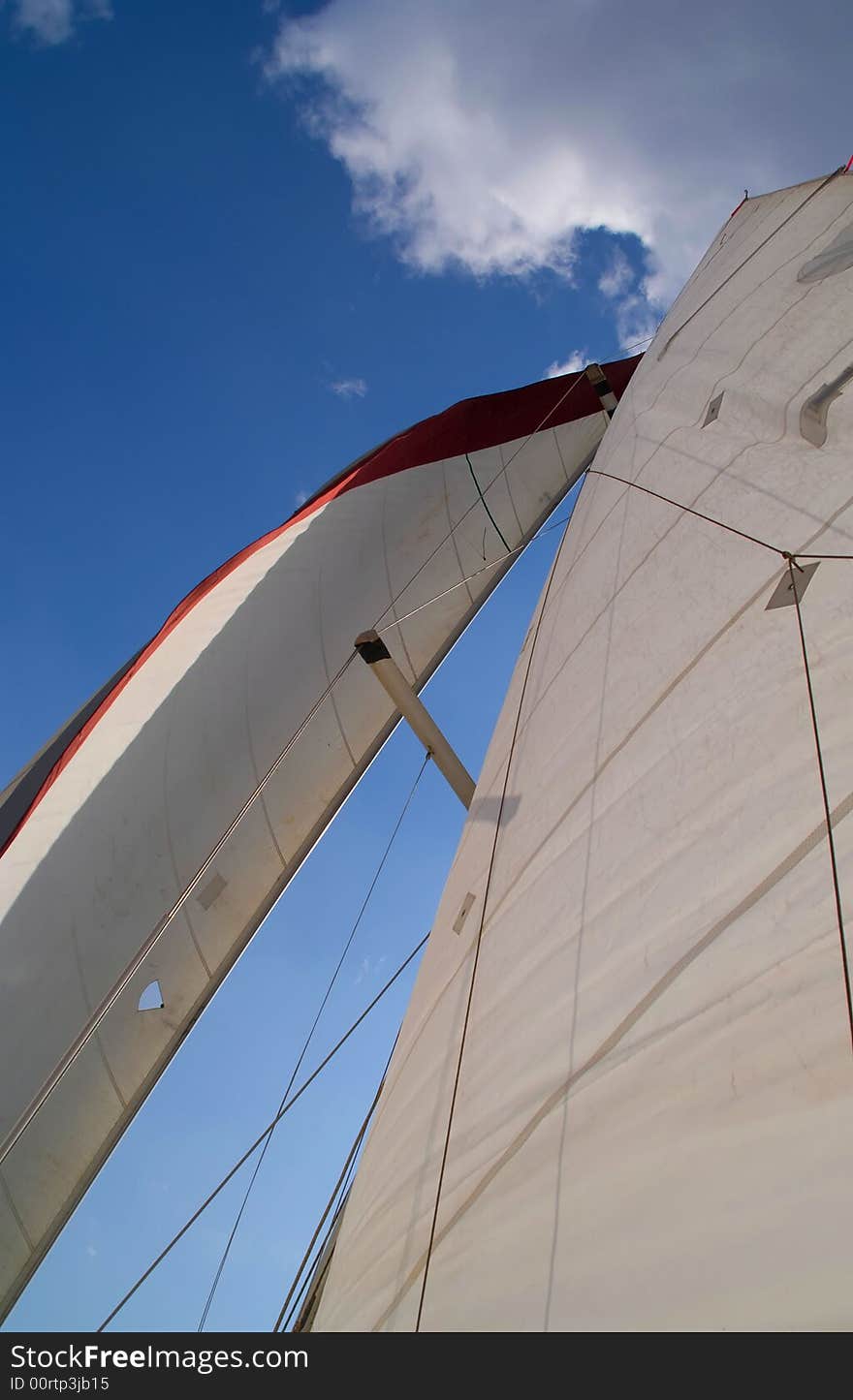 Looking up at sails of boat.