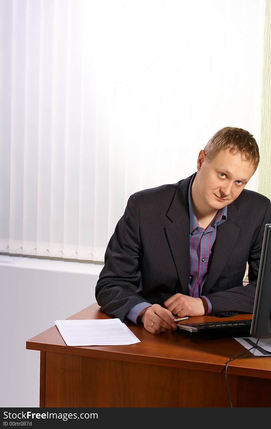 The businessman sitting at a table with a computer