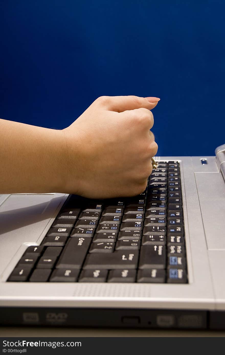 Woman hitting her laptop keyboard. Woman hitting her laptop keyboard