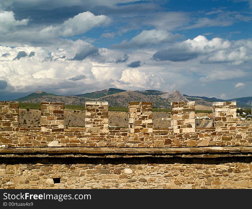 Stone wall and clouds