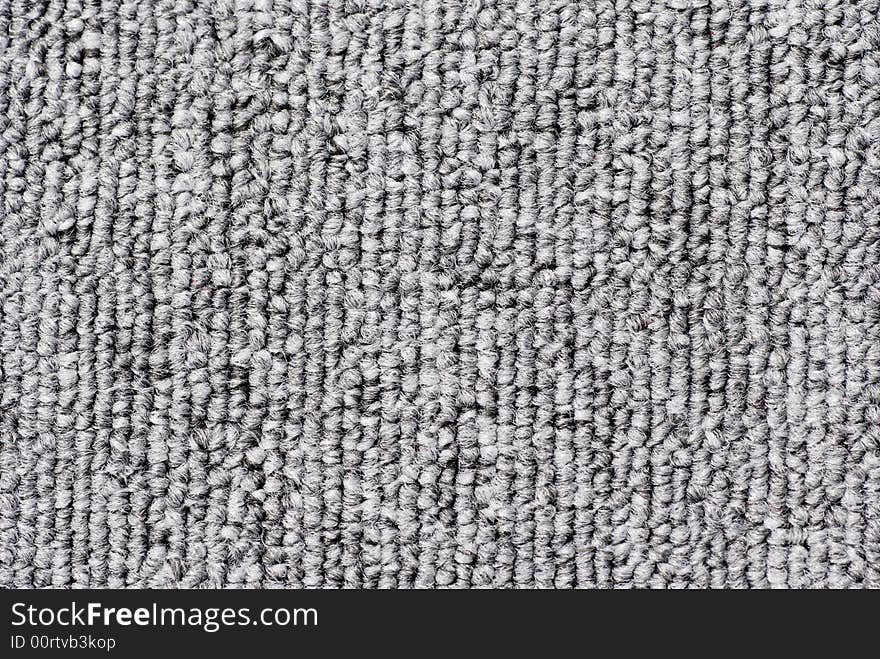 A piece of Grey felt carpet, textured background.