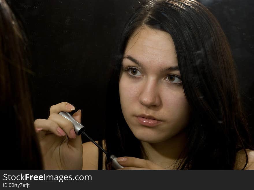 Young girl putting on makeup. Young girl putting on makeup