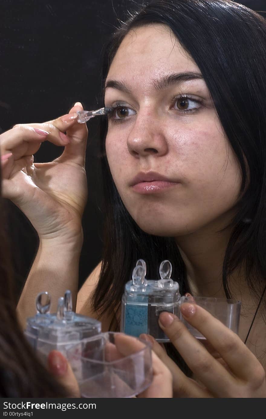 Girl putting on her makeup. Girl putting on her makeup