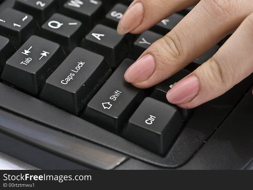 Woman pressing shift button on her keyboard