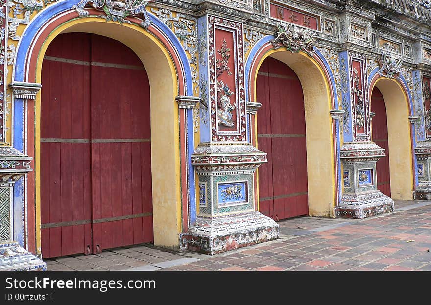 Three red asian doors set in commemorative asian wall. Three red asian doors set in commemorative asian wall