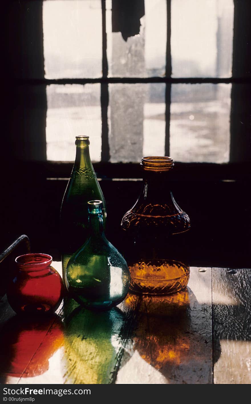 Bottles eminating their color as the sun flows through the window. Bottles eminating their color as the sun flows through the window