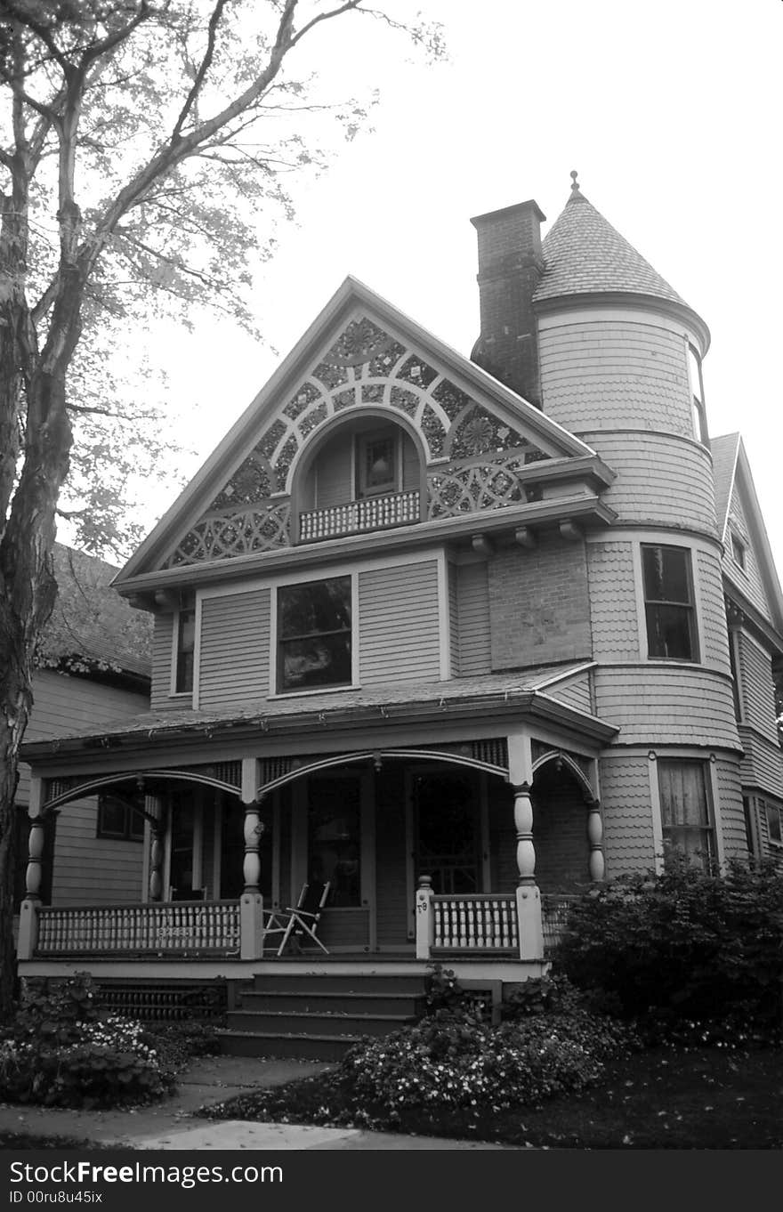 Black and white of the front of an older looking house. Black and white of the front of an older looking house