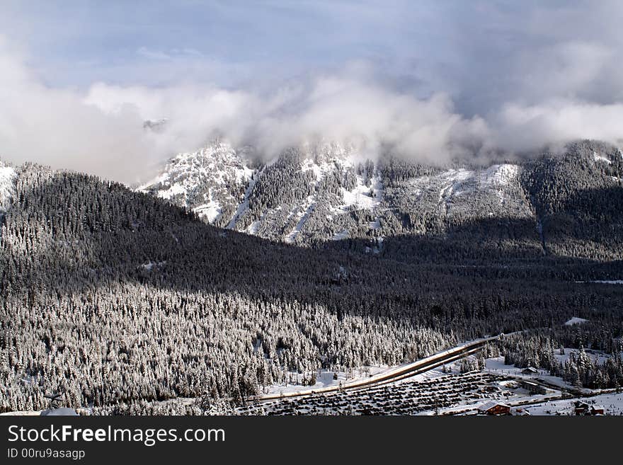 Looking at a snow covered mountain with avalanche areas.