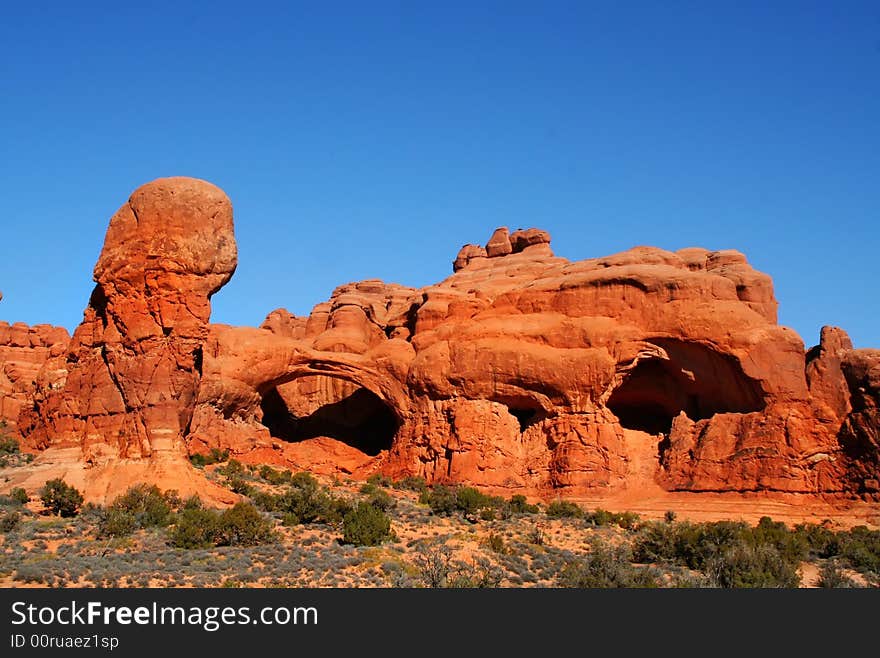 View of the red rock formations in Arches National Park with blue skys. View of the red rock formations in Arches National Park with blue skys