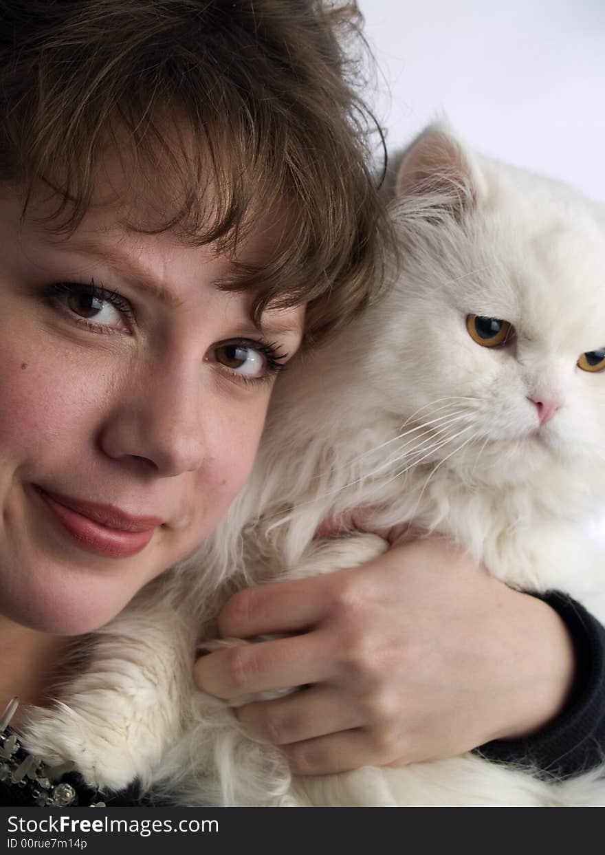 Beautiful young lady white background in glasses holding white cat. Beautiful young lady white background in glasses holding white cat