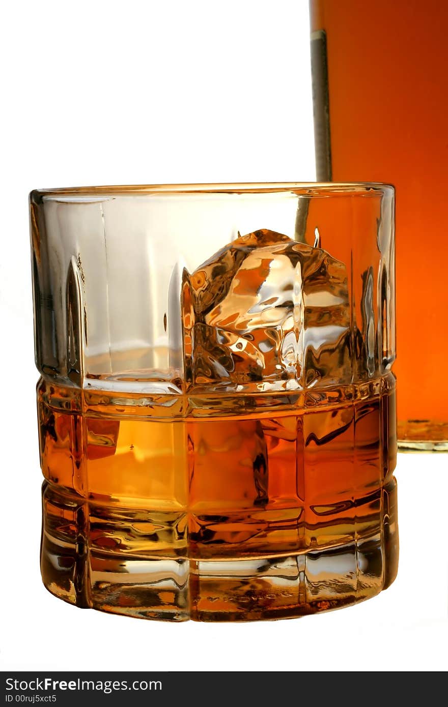 Isolated close-up of bottle and  glass with liquor and ice. Isolated close-up of bottle and  glass with liquor and ice.