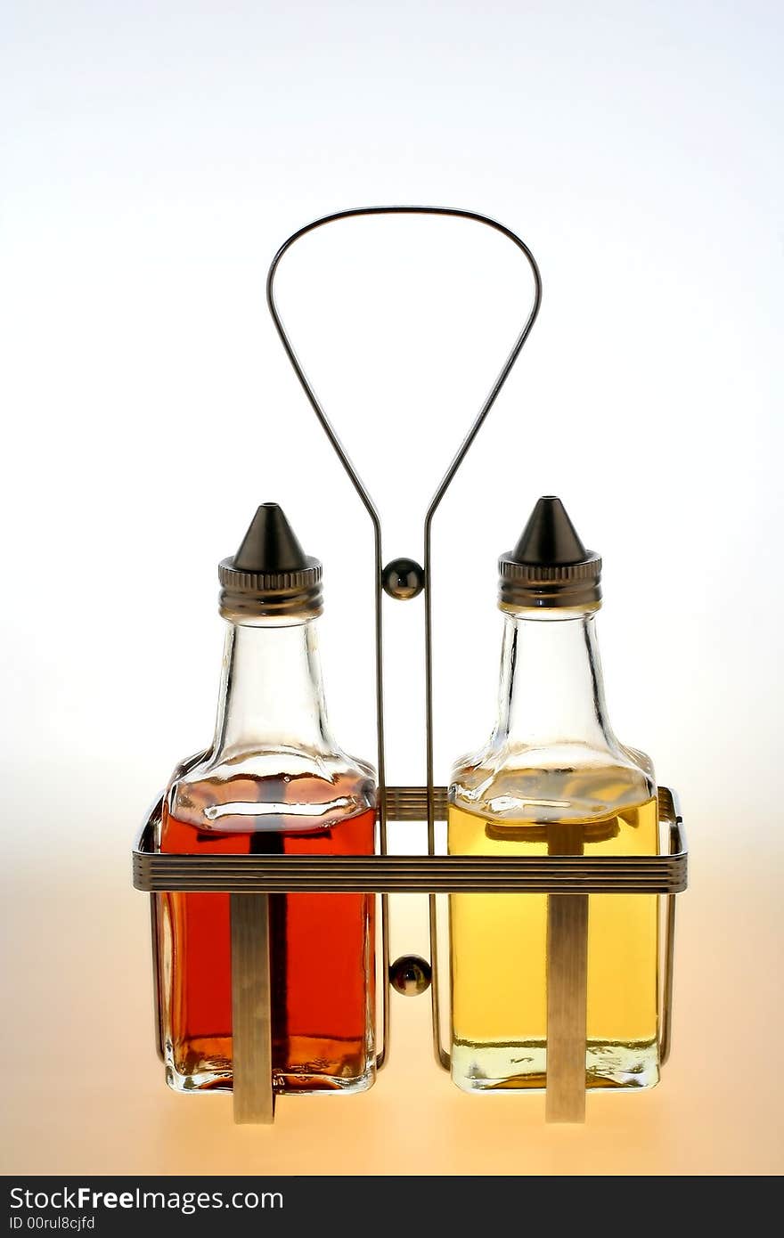 Oil And Vinegar Bottles In Metal Rack