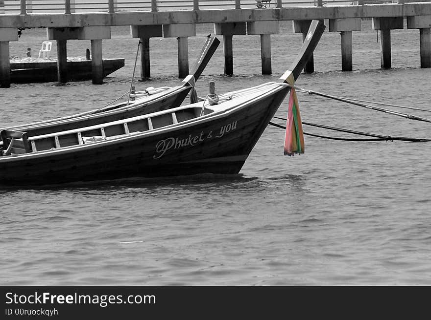 Thai boat in black and white with the prayer cloth in colour and wrapped around the neck of the boat. Thai boat in black and white with the prayer cloth in colour and wrapped around the neck of the boat.