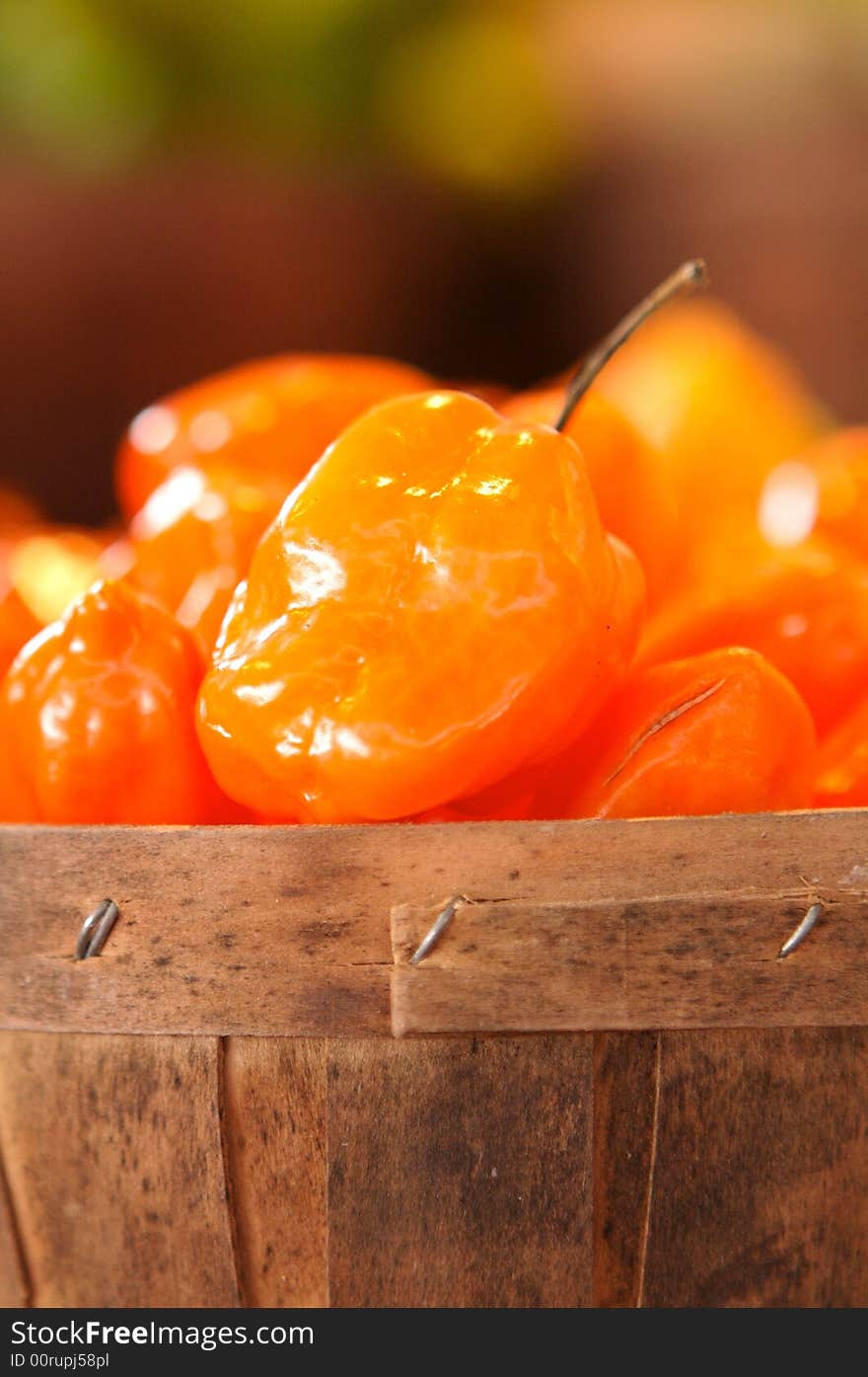 Habanero peppers for sale in a basket on a open air market stall