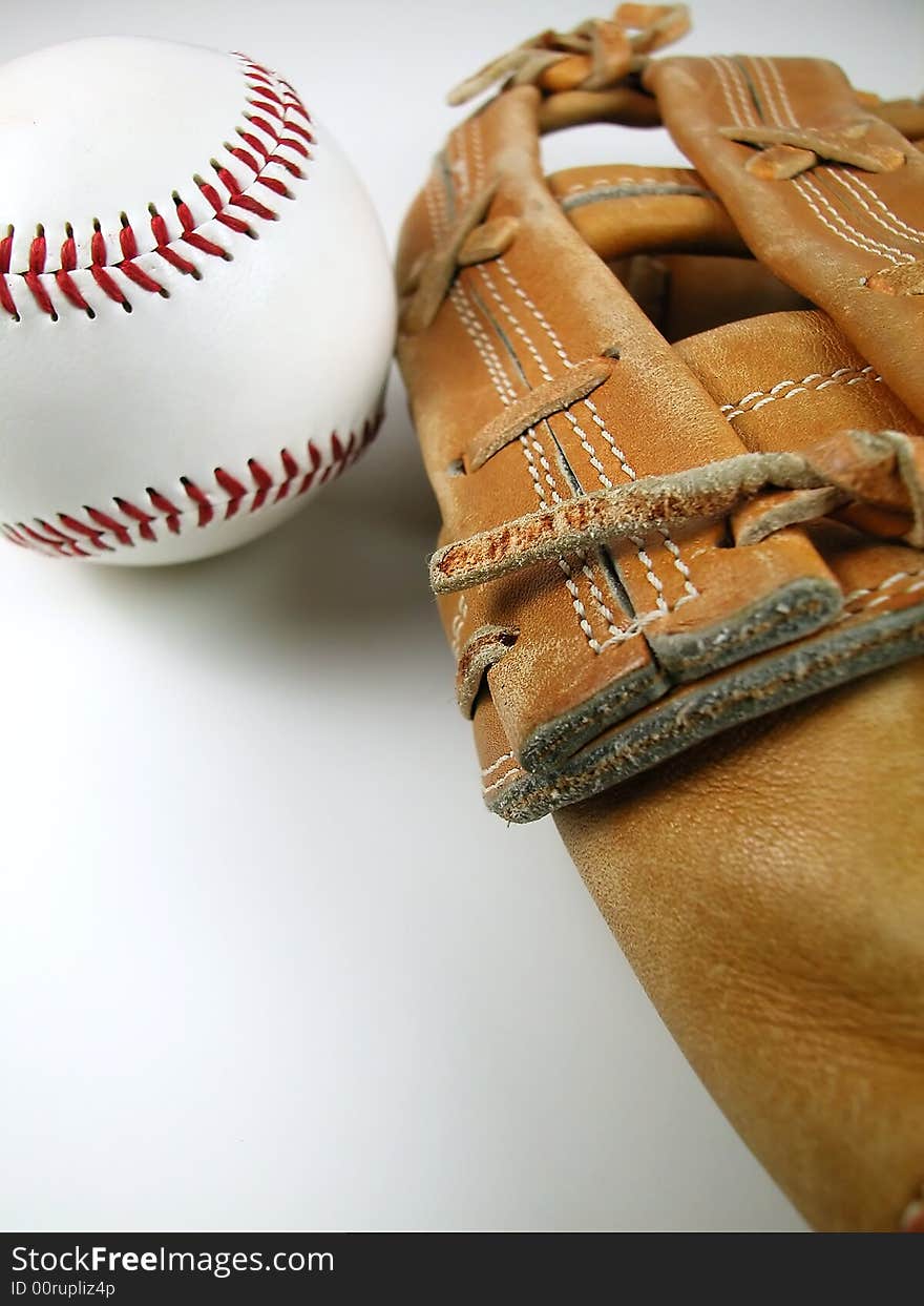 Macro shot of a baseball and mitt with a white background. Macro shot of a baseball and mitt with a white background