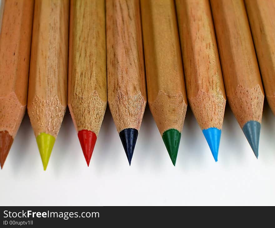 Macro shot of sharpened, natural wood colored pencils with shavings. Macro shot of sharpened, natural wood colored pencils with shavings