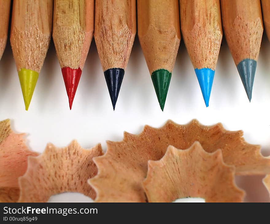 Macro shot of sharpened, natural wood colored pencils with shavings. Macro shot of sharpened, natural wood colored pencils with shavings