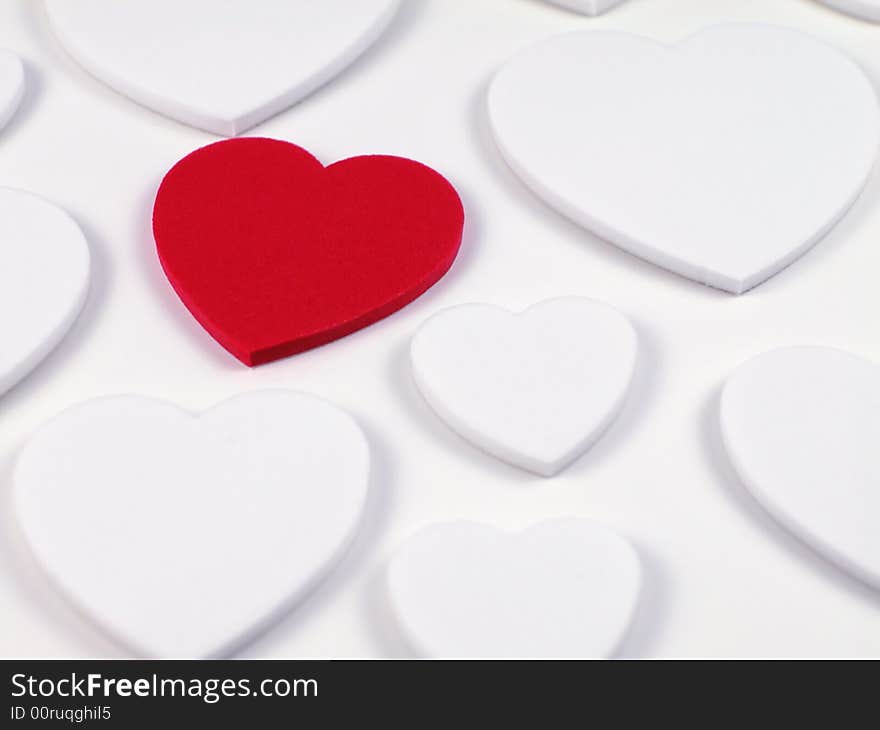 Soft focus shot of a single racy red heart surrounded by plain white hearts, great as a valentines background. Soft focus shot of a single racy red heart surrounded by plain white hearts, great as a valentines background