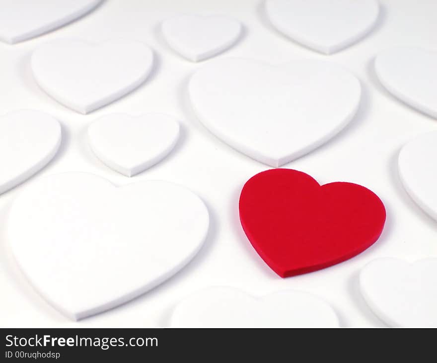 Soft focus shot of a single racy red heart surrounded by plain white hearts, great as a valentines background. Soft focus shot of a single racy red heart surrounded by plain white hearts, great as a valentines background