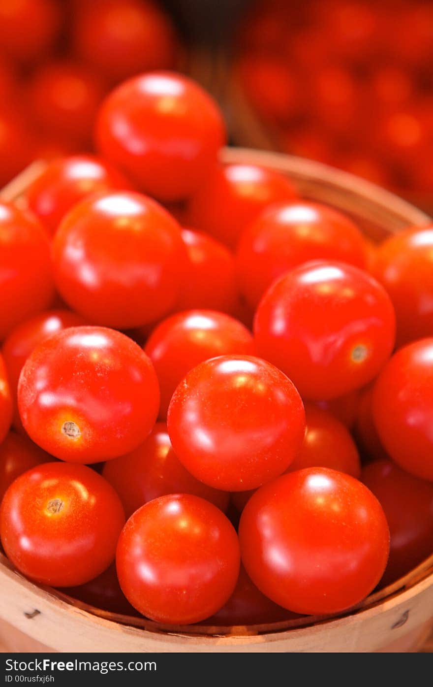 Tomatoes for sale in a basket on a open air market stall. Tomatoes for sale in a basket on a open air market stall