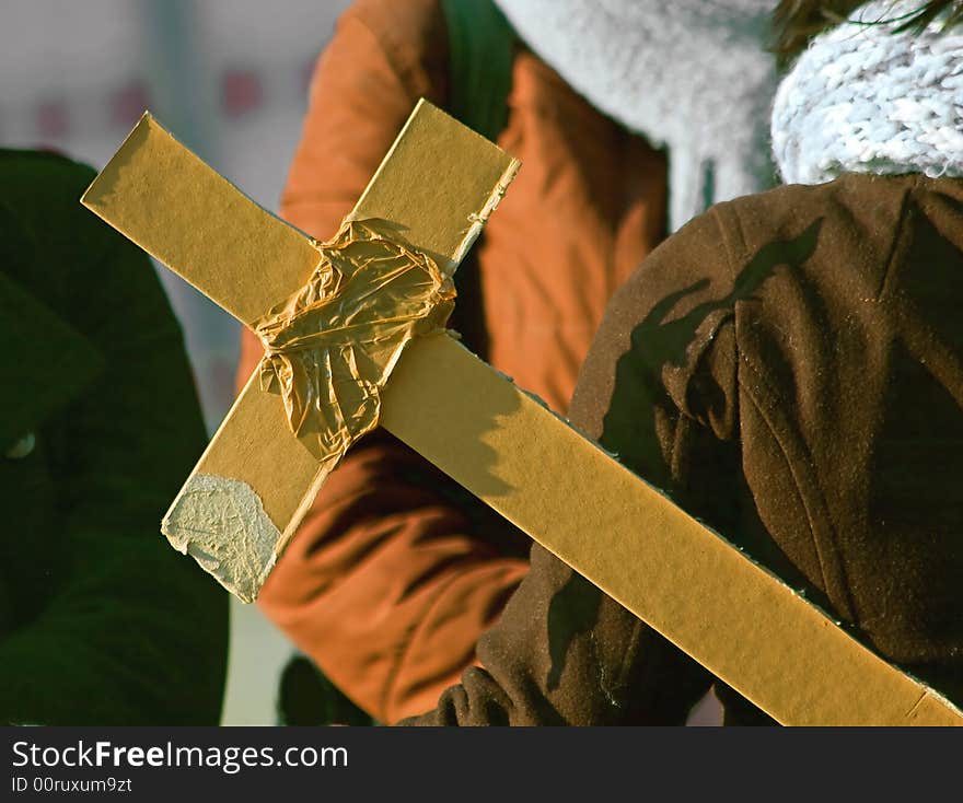 Cardboard cross carried by a woman