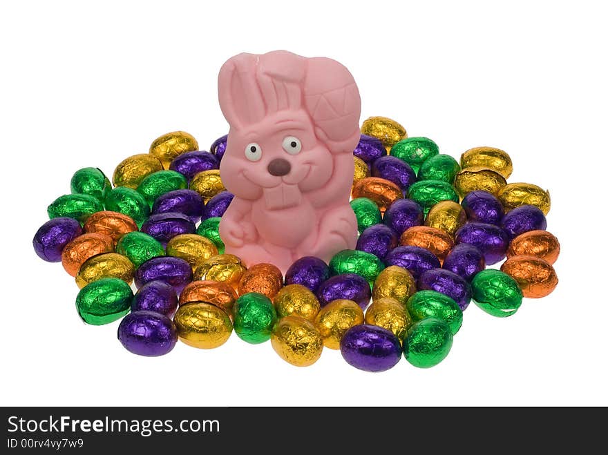 Cute easter bunny surrounded by easter eggs isolated on a white background