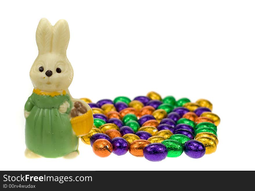 Cute easter bunny surrounded by easter eggs isolated on a white background